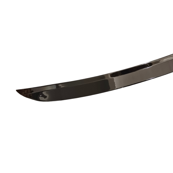 A sleek, curved sword blade with a reflective surface, set against a plain white backdrop, highlighting its polished and slightly arched design.