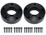 Two black circular metal spacers with central holes and five smaller holes each, accompanied by twenty black bolts, are arranged on a plain white background.