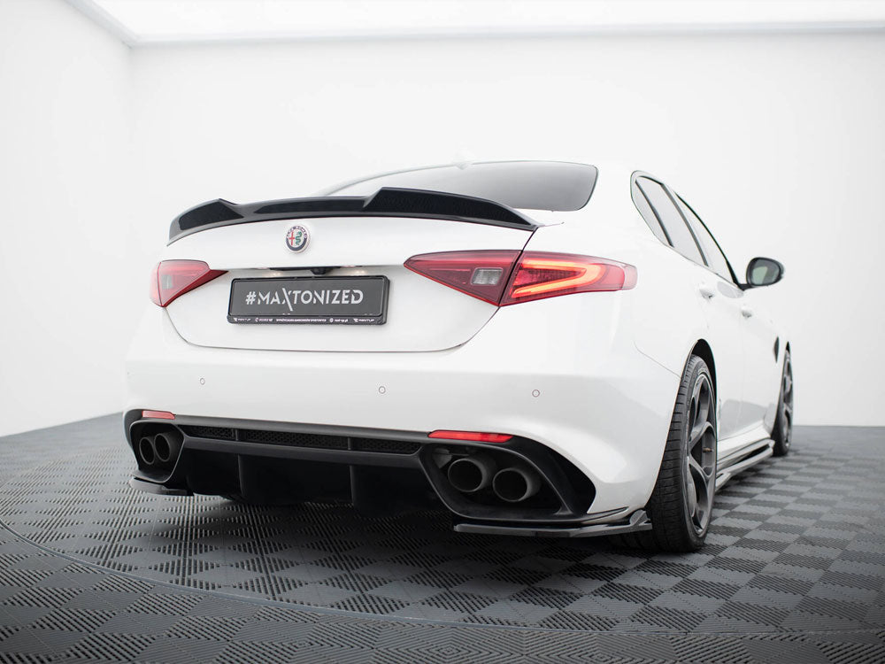 A white sports car, viewed from the rear, sits on a black checkered floor in a bright, minimalist room. The license plate reads "#MAXTONIZED."