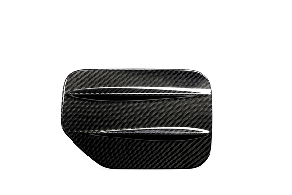 A carbon fiber car part with two horizontal slits, resembling a vent or louver, set against a plain white background.