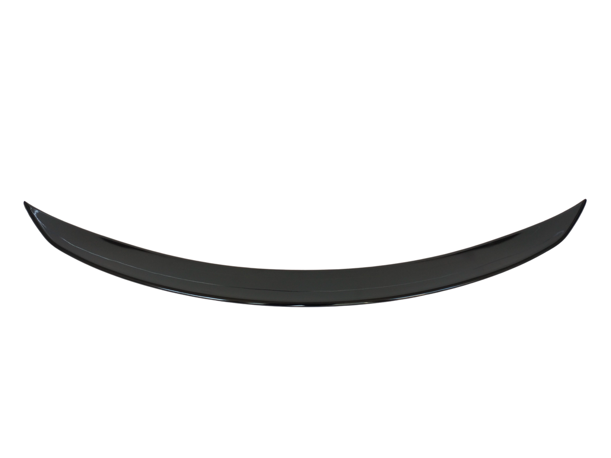 A black, crescent-shaped object curves upward, possibly a car spoiler, set against a plain white background.