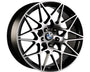 A multi-spoke alloy wheel with geometric patterns features the BMW logo at the center. It has a metallic finish and is designed for automotive use.