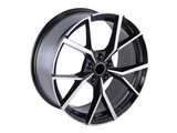 A black and silver alloy wheel with a geometric, angular spoke design, positioned upright against a plain white background.