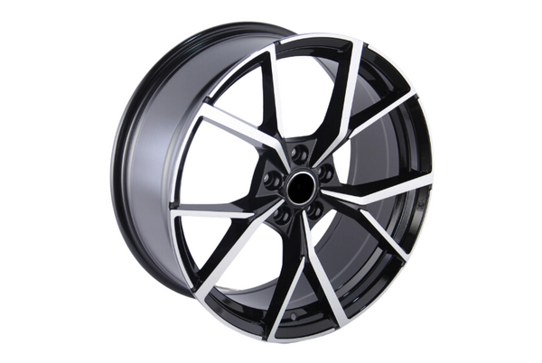 A black and silver alloy wheel with a geometric, angular spoke design, positioned upright against a plain white background.