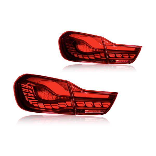 Two red car taillights are placed against a plain white background. The taillights are sleek, featuring intricate patterns and defined sections, reflecting modern automotive design.