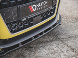 Car front bumper with a Maxton design plate featuring Audi's logo; it rests on a textured, concrete surface. Text: 