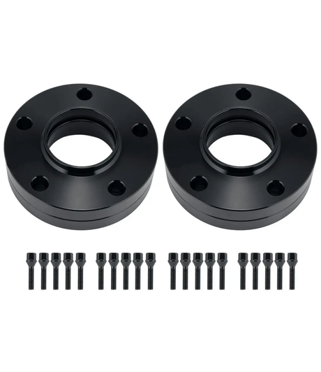 Two black circular wheel spacers, each with five bolt holes, lie side by side. Below, twenty matching black bolts are lined up in two rows on a white background.