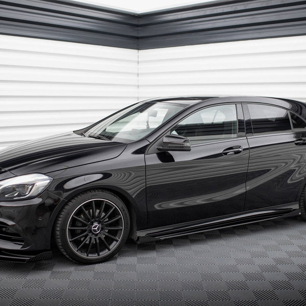 A sleek black hatchback car is parked in a modern garage with textured white and grey walls, featuring glossy black rims and tinted windows.
