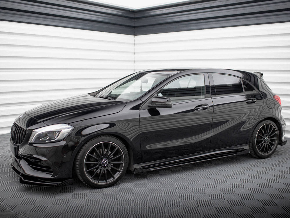 A sleek black hatchback car is parked in a modern garage with textured white and grey walls, featuring glossy black rims and tinted windows.