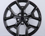 Black, glossy, multi-spoke alloy wheel; resting upright in a well-lit studio setting; casting a slight shadow on the white background.