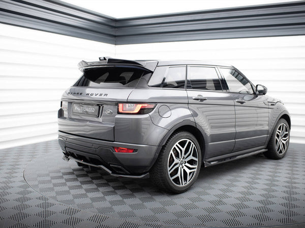 A gray Range Rover is parked on a checkered floor in a well-lit space, featuring "RANGE ROVER" text on the back and a license plate reading "#MAxtonized".