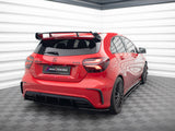 A red Mercedes A 45 AMG is stationary in a modern, brightly lit room with checkered flooring and striped walls. License plate reads 