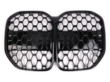 A black, honeycomb-patterned, dual-section car grille with a glossy finish lies against a plain white background, designed for automotive front-end ventilation and style enhancement.