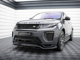 A gray Range Rover is parked in a garage with checkered flooring. The front bumper features a 