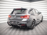 A grey BMW car is parked in a showroom with patterned flooring and white paneled walls. The car has 