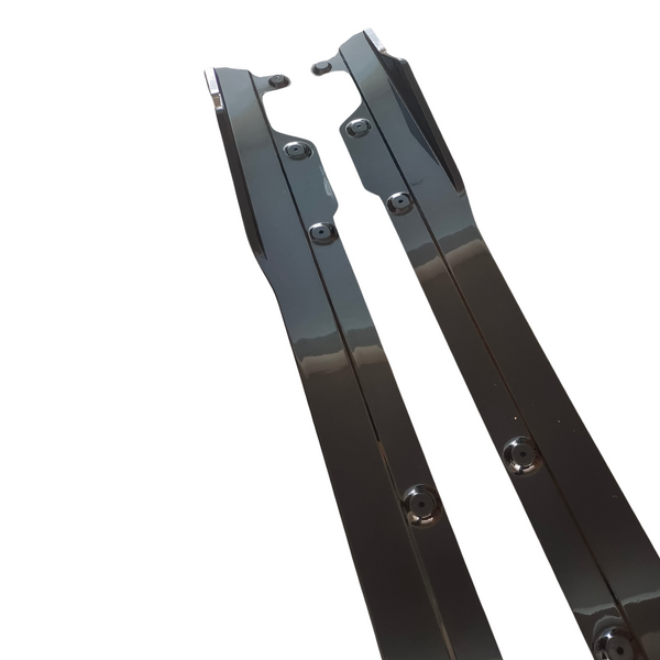 Two sleek, black metal rails with screw holes on a white background, likely components for a mechanical or industrial application.