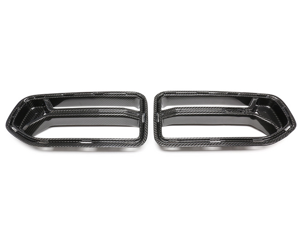 Two carbon fiber exhaust tip covers are displayed side by side on a plain white background, showcasing their sleek, aerodynamic design.