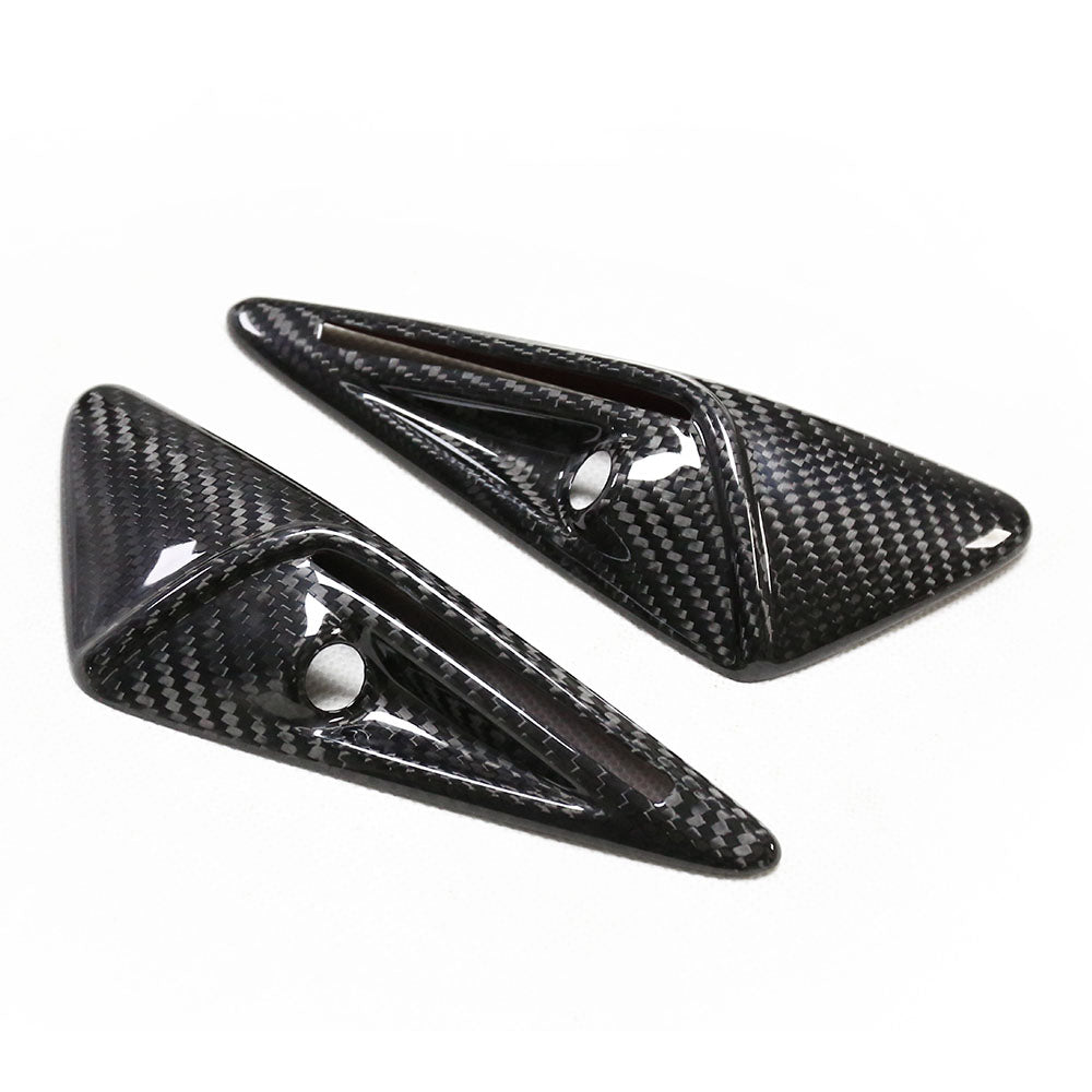 Two carbon fiber car spoiler fins, featuring a sleek design with aerodynamic ridges and mounting holes, sit side by side on a plain white background.