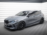 A sleek gray hatchback car with sporty black wheels is parked in a well-lit garage. The words 