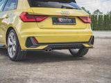 A yellow car is parked on a concrete surface, showcasing its rear view with a visible dual exhaust. The number plate reads "MAXTON Design Auto Special Kraków tel. 12 639 30 50."