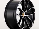A sleek black alloy wheel with a silver trim and an emblem at the center, displayed in profile against a plain white background.