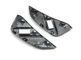 Two black triangular carbon-fiber car parts with clips, lying on a white surface. Labels on each read “L8?” and “L82.” One displays a small logo labeled “OTOSPIRIT.”