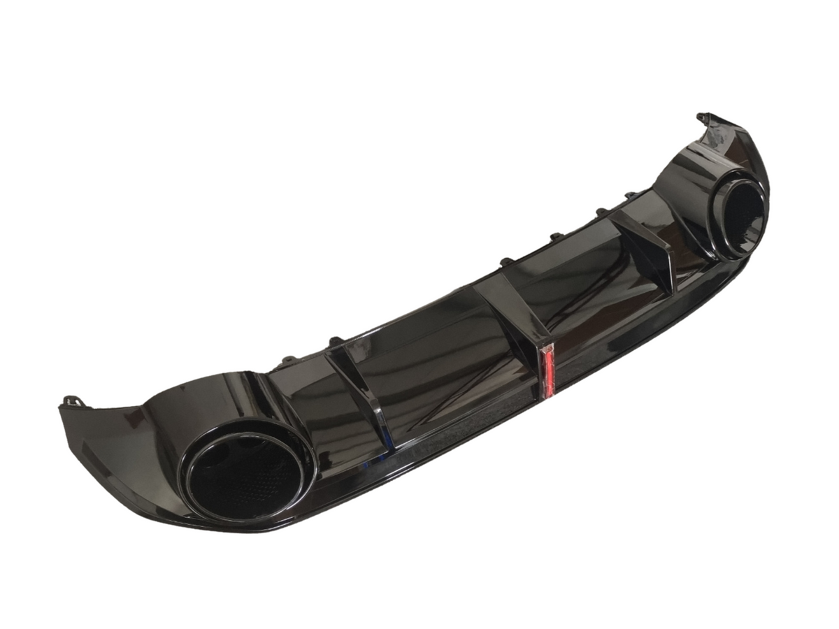 A glossy black automotive rear diffuser with circular exhaust outlets and aerodynamic fins is isolated against a white background, highlighting its sleek design for improved vehicle performance.