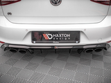 The car's rear section displays a Maxton Design bumper with a quad exhaust system, positioned on a patterned floor. The vehicle's badge and branding elements are visible.