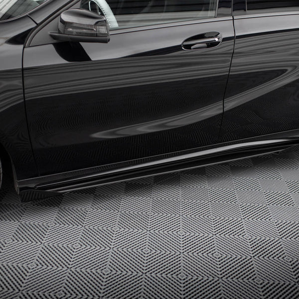 A black car is parked on a patterned surface, featuring prominent reflections and sleek, aerodynamic lines, with a visible side mirror and alloy wheels against a geometric background.