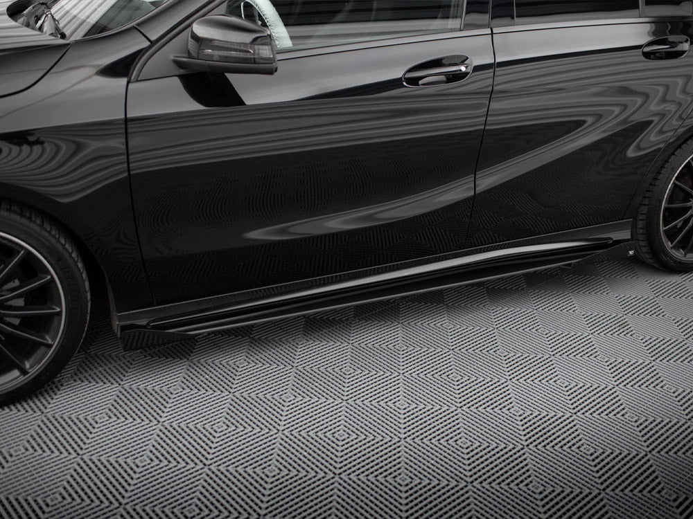 A black car is parked on a patterned surface, featuring prominent reflections and sleek, aerodynamic lines, with a visible side mirror and alloy wheels against a geometric background.
