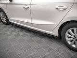 Car parked on a textured gray floor, showing the side doors and tires, with a visible step below the doors. No text is present.