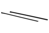 Two long, black plastic rails are placed parallel to each other on a white background, each with a series of evenly spaced grooves.