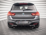A gray BMW car, positioned stationary, displays dual exhausts and illuminated tail lights in a well-lit showroom. Text: 