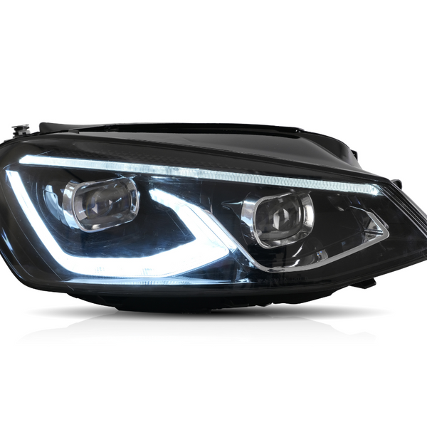 A car headlight is illuminated, showcasing its LED design with a sleek, angular shape. It is set against a plain white background, emphasizing its modern aesthetic.