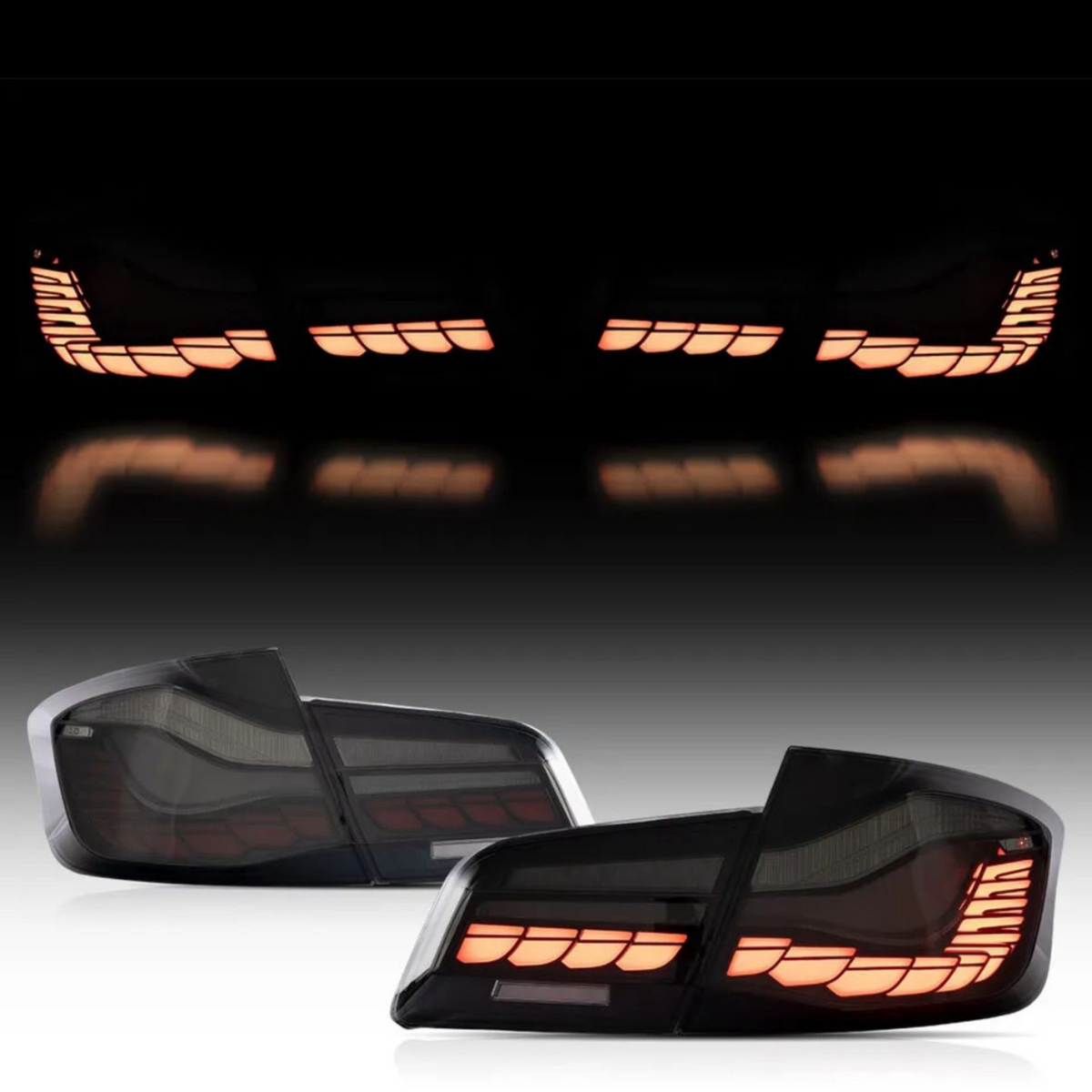 Two car taillights, illuminated with segmented orange lights, are positioned against a dark background, reflecting on a glossy surface.