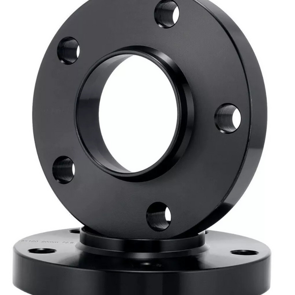 A black circular metal flange with a central hole and multiple bolt holes is displayed in front of a similar flange, set against a plain white background.