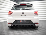 A white car is parked in a showroom. The rear features the text 