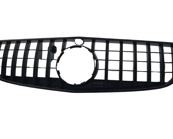 A black car grille features vertical and horizontal slats forming a rectangular pattern, with a circular opening in the center, set against a plain white background.