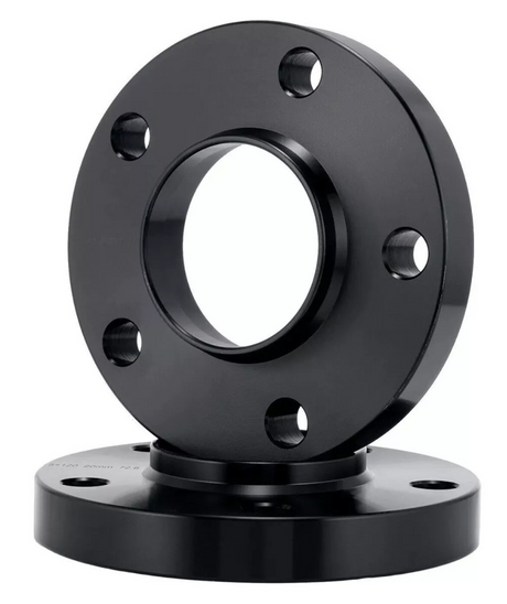 A black metal flange with six bolt holes stands upright, placed atop a similar base flange, in a plain white background.