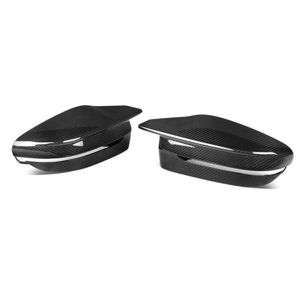 Two carbon fiber side mirror covers are displayed, resting separately, against a plain white background, highlighting their sleek, aerodynamic shape and glossy finish.