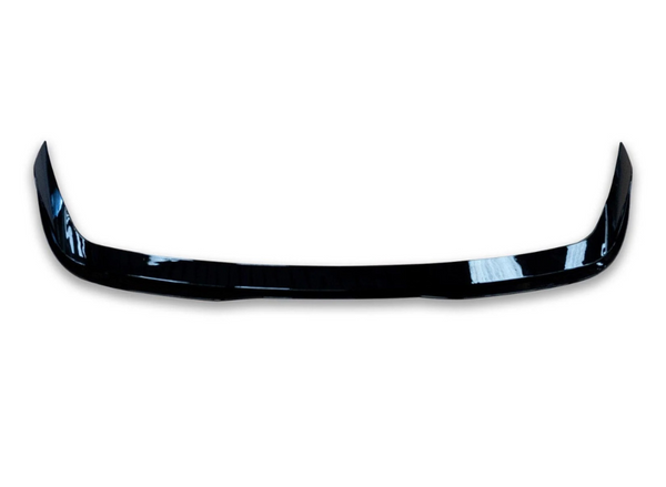 A glossy black car spoiler, curving slightly upward at each end, isolated on a plain white background.