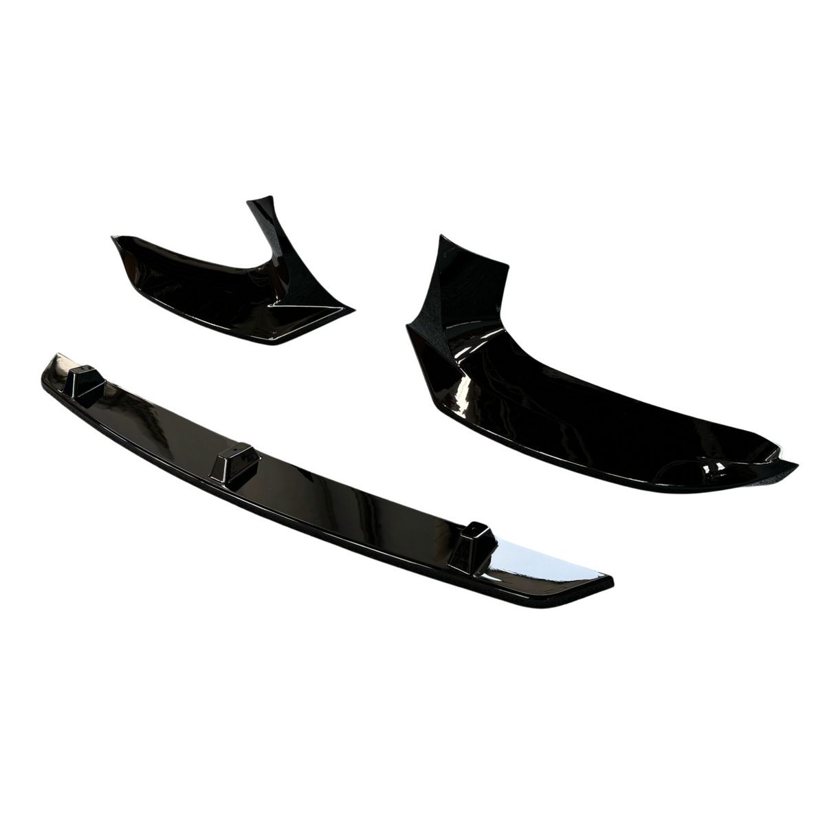 Three glossy black car spoilers lie separately on a plain white background, showcasing different angles and designs.