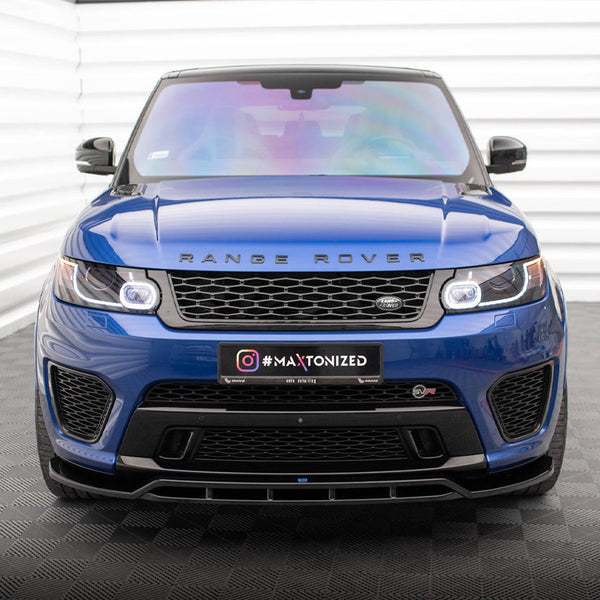 A blue Range Rover is parked indoors on a patterned floor. The front grille displays the logo, with "#MAXTONIZED" on the license plate. The setting includes white paneled walls.