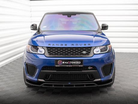 A blue Range Rover is parked indoors on a patterned floor. The front grille displays the logo, with "#MAXTONIZED" on the license plate. The setting includes white paneled walls.