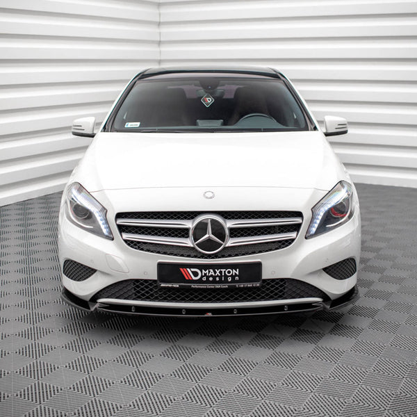 A white Mercedes-Benz car is parked in a room with patterned floors and striped walls. A front license plate reads "MAXTON design."