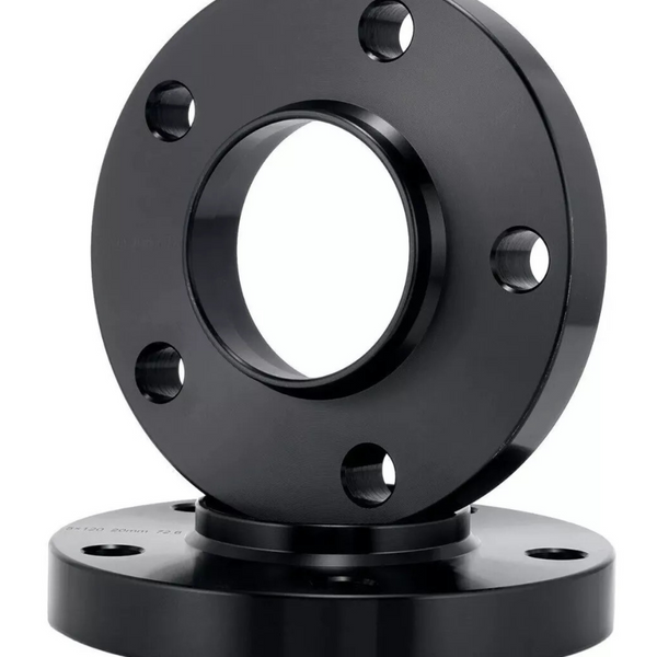 Two black metal flanges with multiple bolt holes are stacked vertically; the top flange is positioned upright. The setting appears to be a plain white studio background.