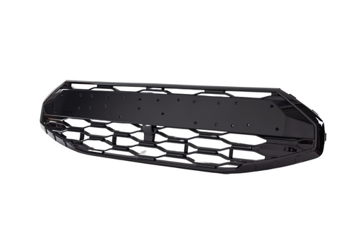 A black car front grille with a hexagonal mesh pattern is isolated against a white background. The grille has a solid center plate, likely for mounting purposes.