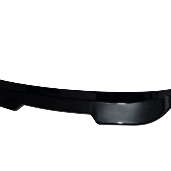 A glossy black car spoiler, gently curved with upward tips, rests in isolation on a plain, white background.