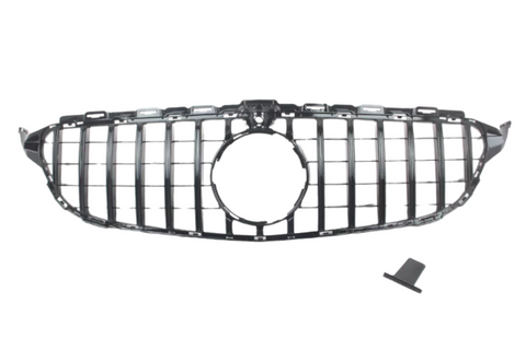 A car grille with vertical slats, designed for a front bumper, includes a circular central opening, placed on a plain white background. A small, detached piece lies nearby.