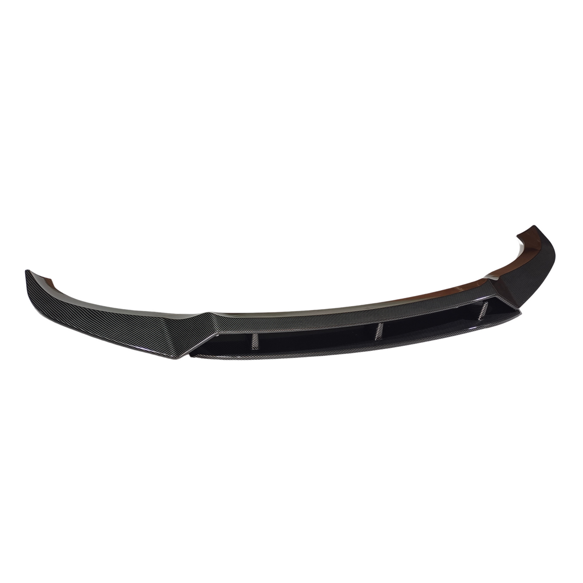 A black carbon fiber car spoiler lies on a white background, featuring a curved shape and aerodynamic design with angular edges and embedded fins.